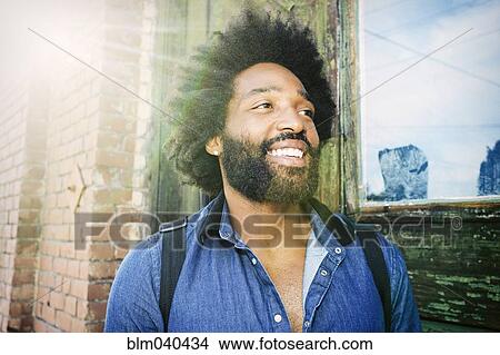 Mixed race musician carrying guitar outdoors View Large Photo Image Picture - Mixed race musician carrying guitar outdoors. Fotosearch
