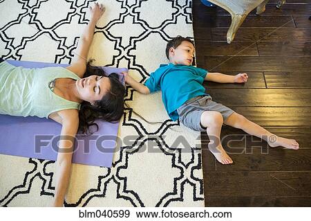 Stock Photo - Mother and son laying on floor. Fotosearch