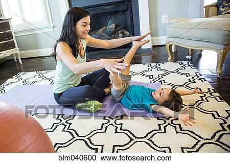 Stock Image - Mother and son playing on floor. Fotosearch