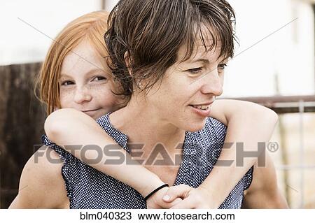 Mother carrying daughter piggyback View Large Photo Image Stock Image - Mother carrying daughter piggyback. Fotosearch