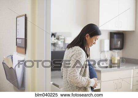 Stock Photography - Pregnant Chinese woman in hospital room. Fotosearch