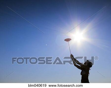 Stock Photo - Silhouette of woman spinning plate. Fotosearch