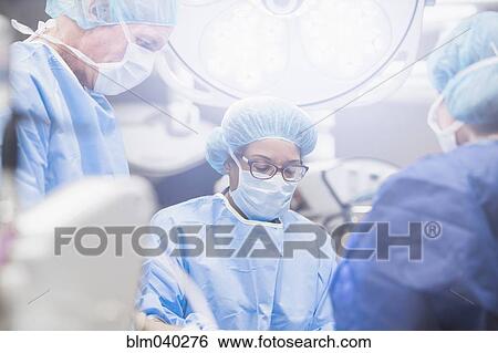 Stock Photograph - Surgeons working in operating room. Fotosearch