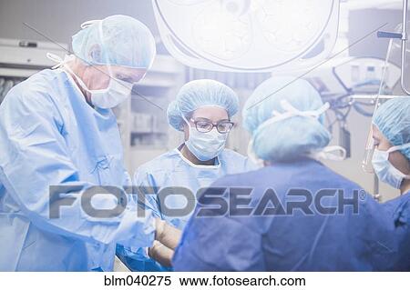Surgeons working in operating room View Large Photo Image Stock Photography - Surgeons working in operating room. Fotosearch