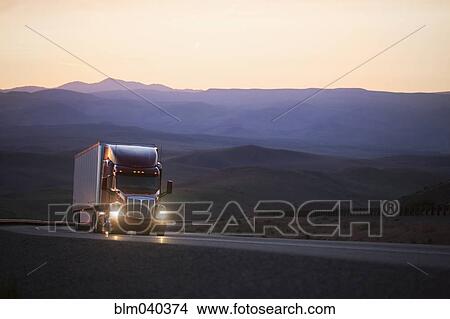 Picture - Truck driving on remote highway. Fotosearch