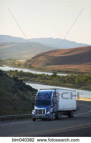 Truck driving on remote highway View Large Photo Image Stock Image - Truck driving on remote highway. Fotosearch