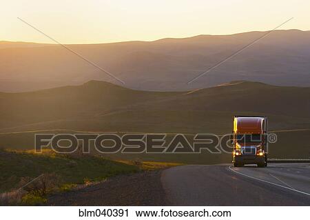 Truck driving on remote highway View Large Photo Image Stock Image - Truck driving on remote highway. Fotosearch