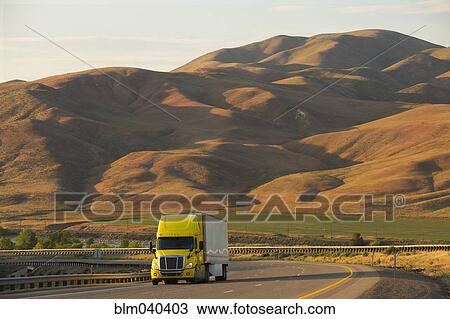 Truck driving on remote highway View Large Photo Image Stock Image - Truck driving on remote highway. Fotosearch