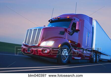 Stock Photo - Truck driving on remote highway. Fotosearch