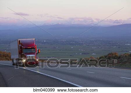 Truck driving on remote highway View Large Photo Image Stock Photo - Truck driving on remote highway. Fotosearch