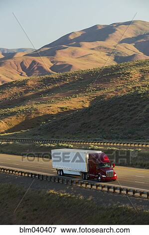 Truck driving on remote highway View Large Photo Image Stock Photo - Truck driving on remote highway. Fotosearch