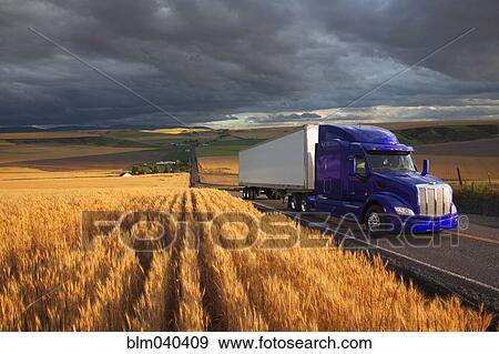 Stock Photo - Truck driving on remote highway. Fotosearch