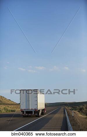 Stock Photography - Truck driving on remote highway. Fotosearch