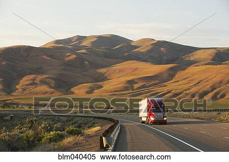 Stock Photography - Truck driving on remote highway. Fotosearch
