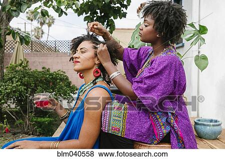 Woman combing hair of friend on front stoop View Large Photo Image Stock Photo - Woman combing hair of friend on front stoop. Fotosearch