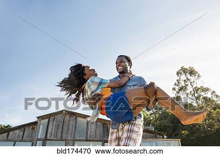 African American man carrying girlfriend View Large Photo Image Stock Image - African American man carrying girlfriend. Fotosearch