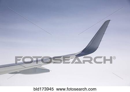 Stock Photography - Airplane wing under clear sky. Fotosearch
