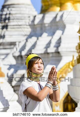 Stock Image - Asian woman doing traditional dance at temple. Fotosearch
