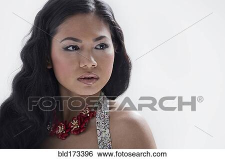 Stock Photograph - Asian woman wearing flower necklace. Fotosearch