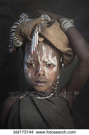 Picture - Black child wearing traditional face paint. Fotosearch