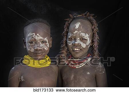 Stock Image - Black children with traditional face paint. Fotosearch