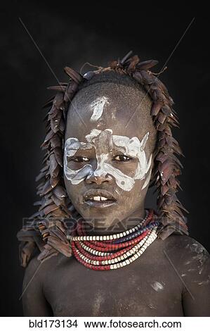 Picture - Black teenage girl wearing traditional face paint. Fotosearch