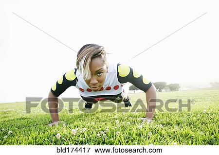 Stock Photo - Black woman doing push. Fotosearch