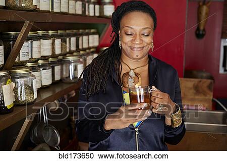 Black woman drinking tea in tea shop View Large Photo Image Stock Image - Black woman drinking tea in tea shop. Fotosearch