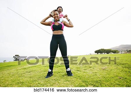 Black woman holding daughter in field View Large Photo Image Stock Photograph - Black woman holding daughter in field. Fotosearch