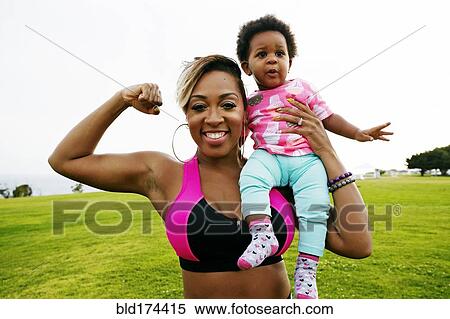 Black woman holding daughter in field View Large Photo Image Stock Photography - Black woman holding daughter in field. Fotosearch