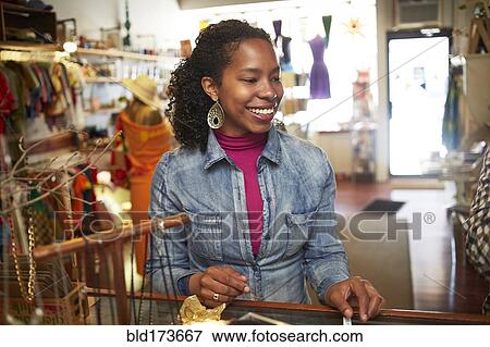 Stock Photo - Black woman shopping in store. Fotosearch