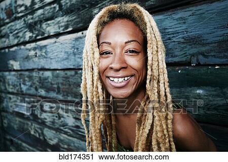 Black woman smiling at wooden wall View Large Photo Image Stock Image - Black woman smiling at wooden wall. Fotosearch