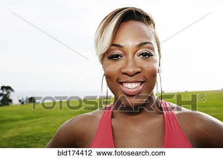Black woman smiling in field View Large Photo Image Stock Image - Black woman smiling in field. Fotosearch