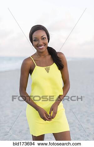 Picture - Black woman smiling on beach. Fotosearch