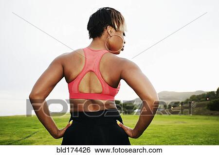 Black woman standing in field View Large Photo Image Stock Photograph - Black woman standing in field. Fotosearch