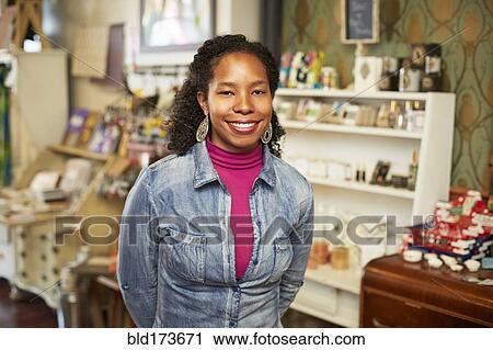 Black woman standing in store View Large Photo Image Stock Image - Black woman standing in store. Fotosearch