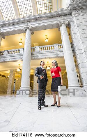 Stock Photograph - Business people talking in courthouse. Fotosearch