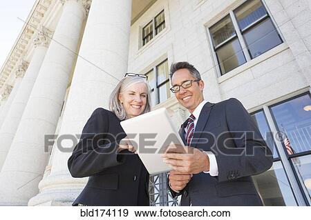 Stock Photo - Business people talking outside courthouse. Fotosearch
