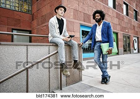 Businessmen at banister on walkway View Large Photo Image Stock Image - Businessmen at banister on walkway. Fotosearch