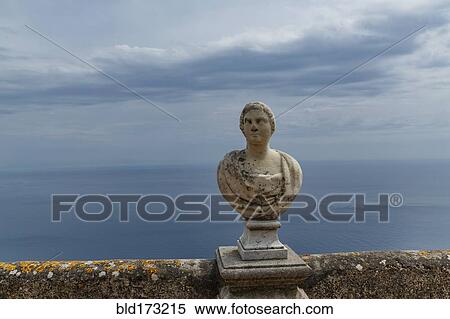 Stock Photography - Carved bust on balcony over seascape. Fotosearch