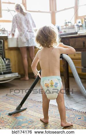Caucasian boy helping mother do chores View Large Photo Image Stock Photograph - Caucasian boy helping mother do chores. Fotosearch