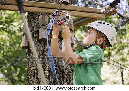 Caucasian boy hooking harness to zip View Large Photo Image Stock Image - Caucasian boy hooking harness to zip. Fotosearch