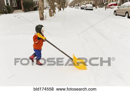 Caucasian boy shoveling snow View Large Photo Image Stock Photo - Caucasian boy shoveling snow. Fotosearch