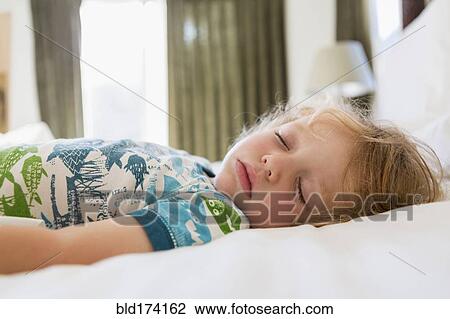 Caucasian boy sleeping on bed View Large Photo Image Stock Image - Caucasian boy sleeping on bed. Fotosearch