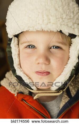 Stock Photograph - Caucasian boy wearing warm hat. Fotosearch