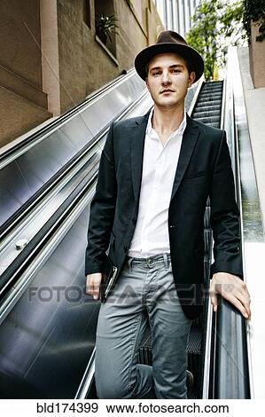 Caucasian businessman on escalator View Large Photo Image Stock Photo - Caucasian businessman on escalator. Fotosearch