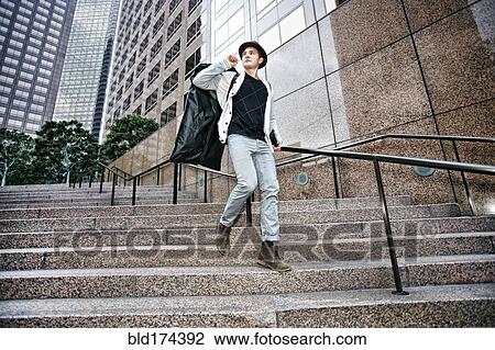 Stock Image - Caucasian businessman walking on steps. Fotosearch