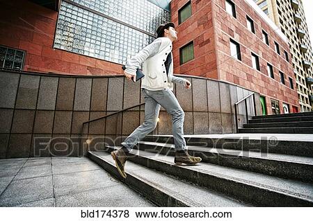 Caucasian businessman walking on steps View Large Photo Image Stock Photo - Caucasian businessman walking on steps. Fotosearch
