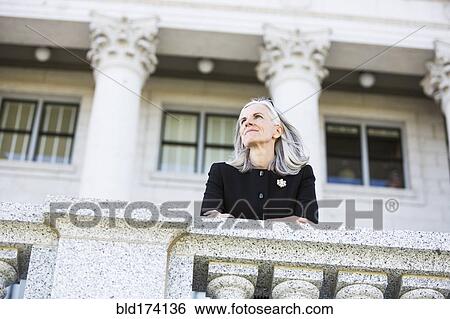 Caucasian businesswoman standing outside courthouse View Large Photo Image Stock Photograph - Caucasian businesswoman standing outside courthouse. Fotosearch