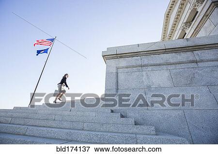 Caucasian businesswoman walking on courthouse steps View Large Photo Image Stock Photo - Caucasian businesswoman walking on courthouse steps. Fotosearch